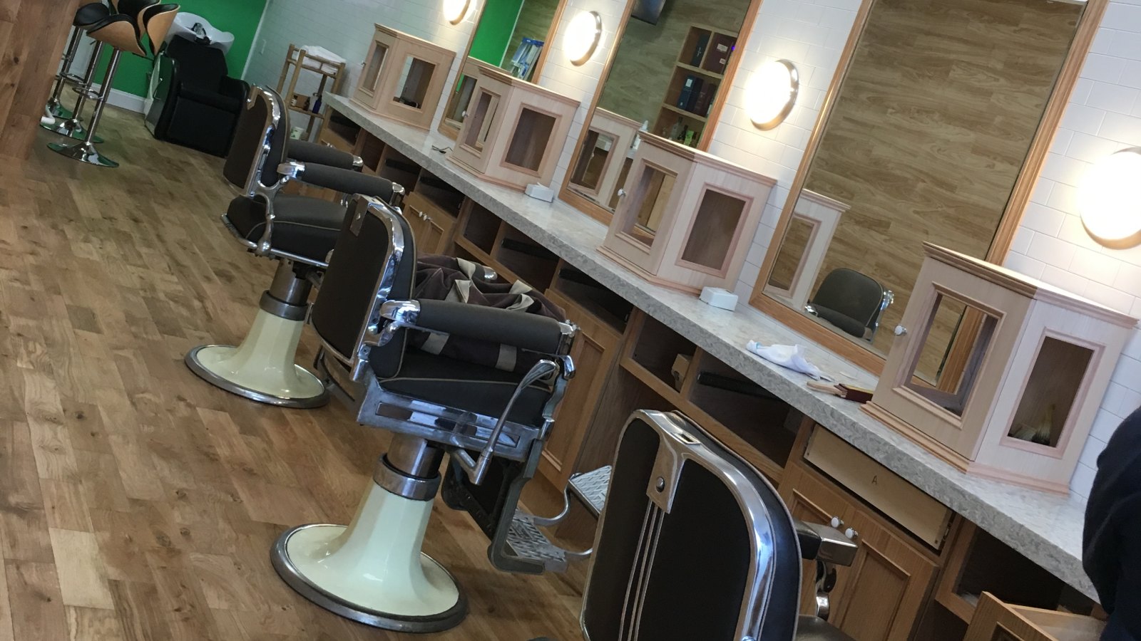 Inside The Silent Barber &mdash; the mirror wall and chairs